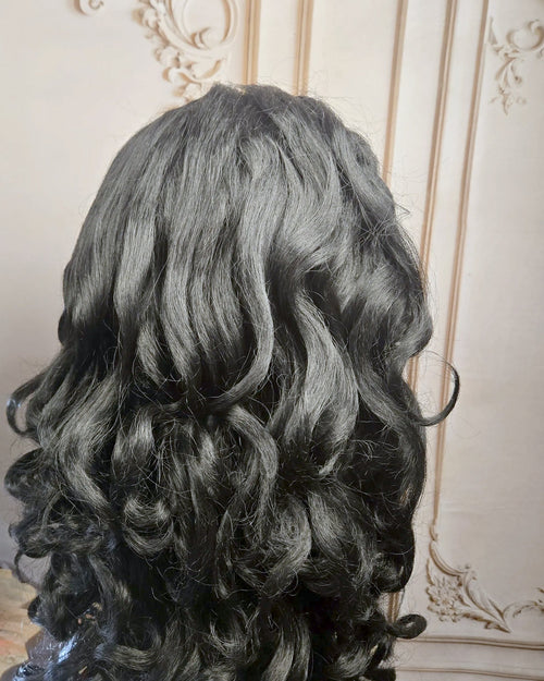 Tresspoint Full Bloom lace front wig in 1B off black, 250 density, shown from the back with loose waves