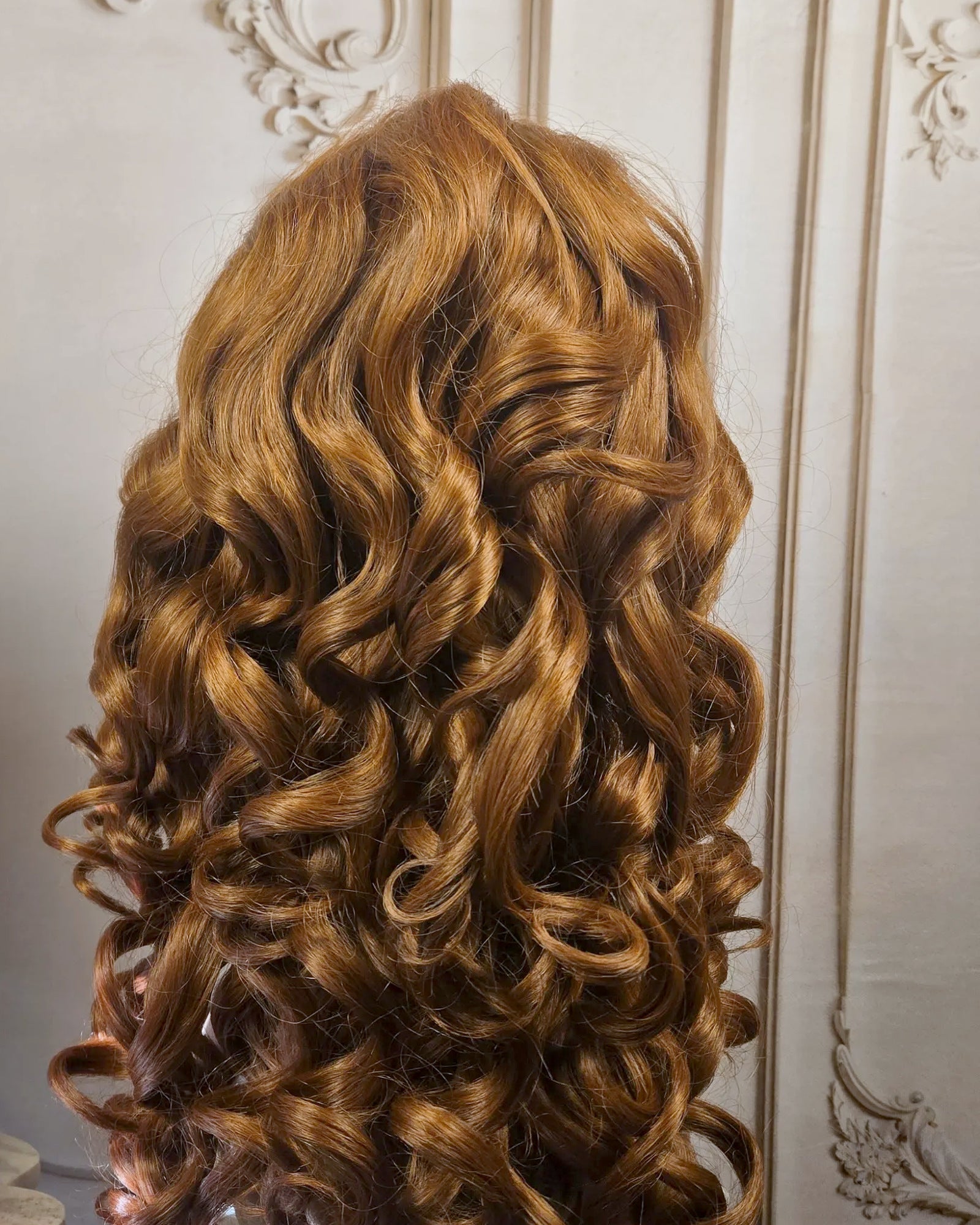 Tresspoint Full Bloom lace front wig in 33B copper auburn, shown from the back with defined curls
