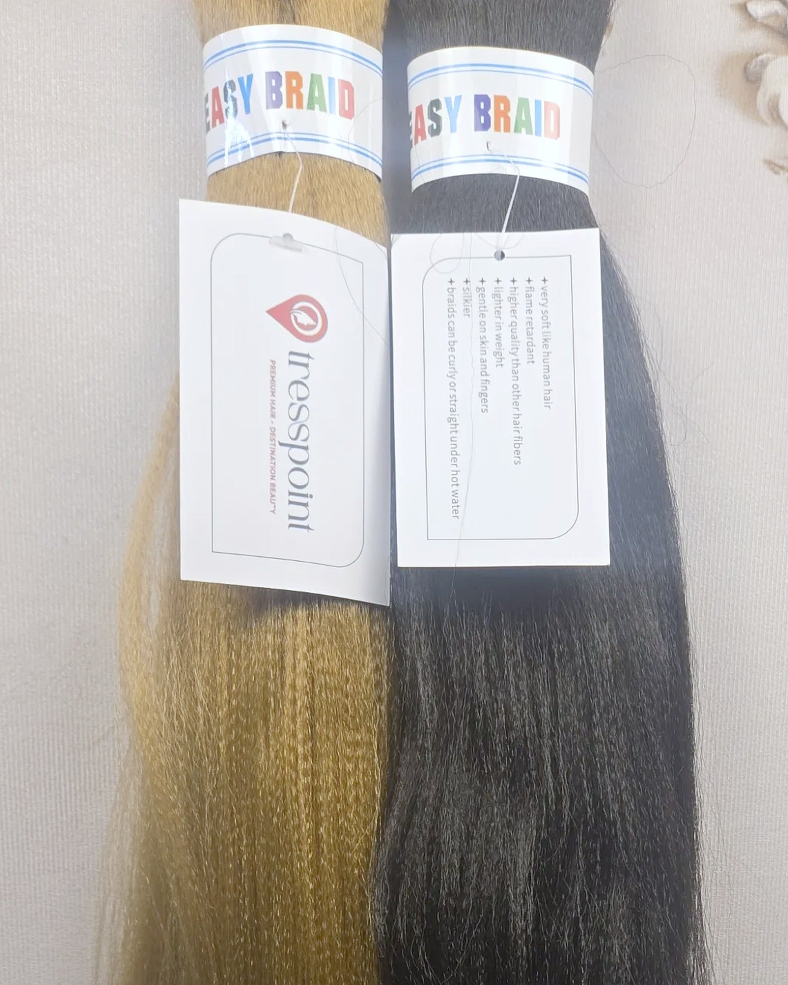 Close detail of Tresspoint Kanekalon braiding hair packaging and fiber texture