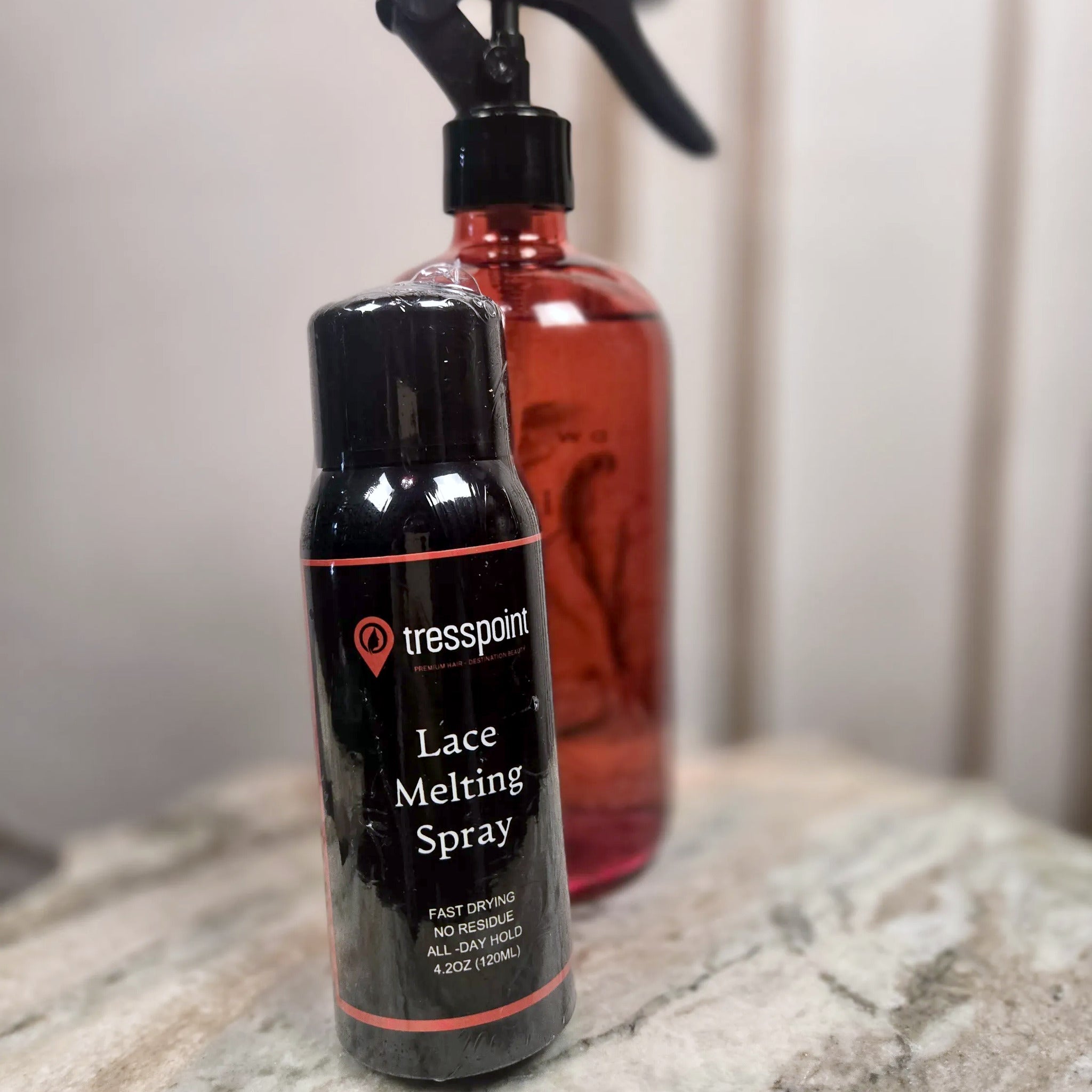 Tresspoint Lace Melting Spray 4.2 oz (120 ml) bottle in black with coral stripes, labeled fast drying, no residue, all-day hold